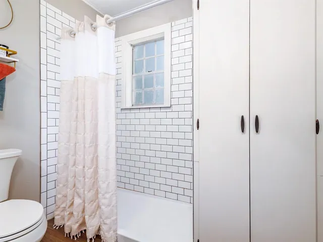 a bathroom with a toilet and shower