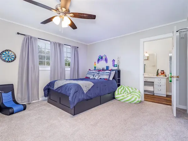 a spacious bedroom with a bed dresser and a window