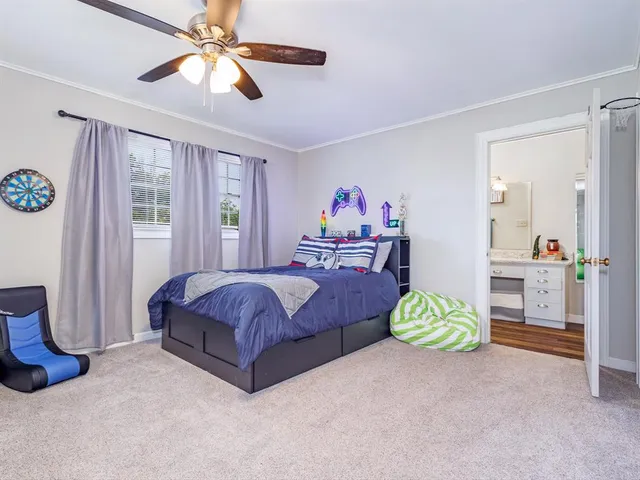 a spacious bedroom with a bed dresser and a window