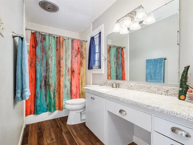 a bathroom with a sink a toilet and a mirror