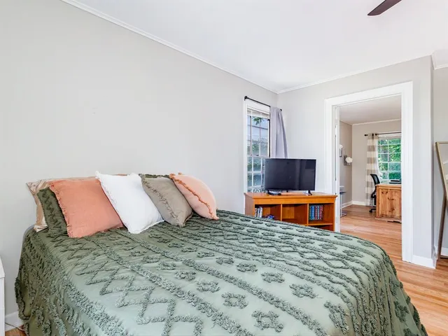 a bedroom with a bed and a television