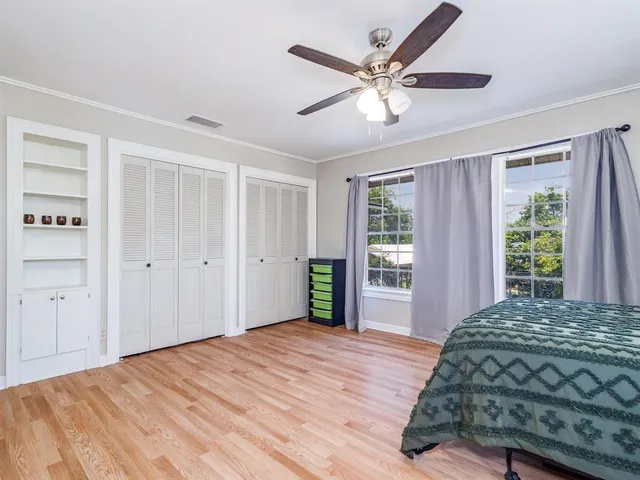 a bedroom with a large bed and a chandelier