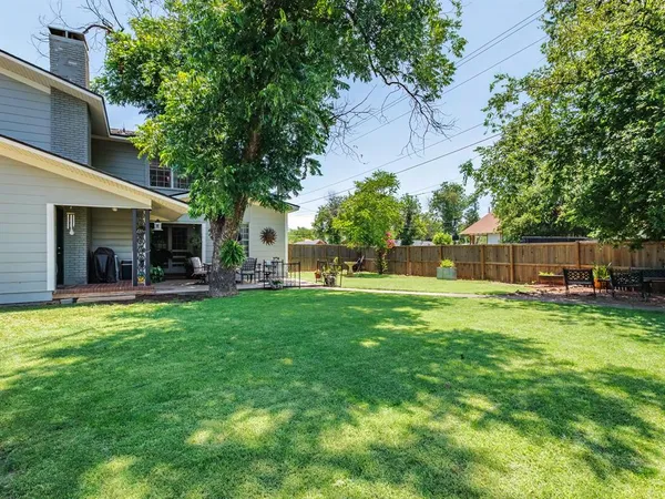 a front view of a house with a yard porch and furniture