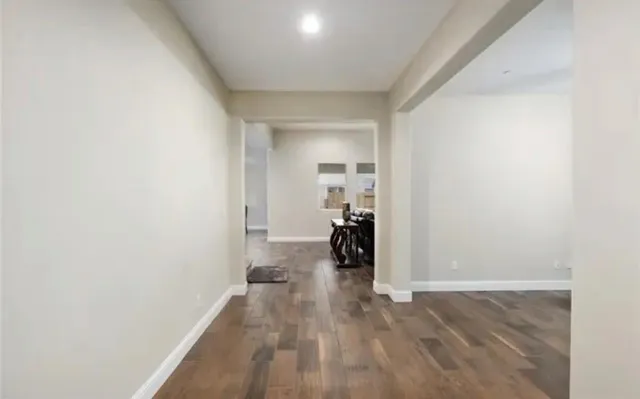 a view of a room with wooden floor