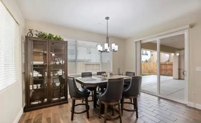 a view of a dining room with furniture wooden floor and chandelier