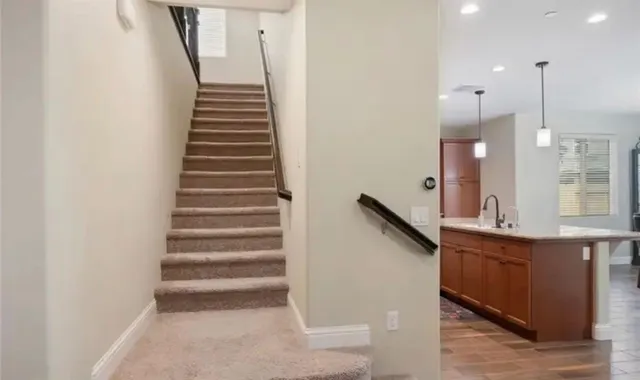 a view of a kitchen with stairs and ventilation