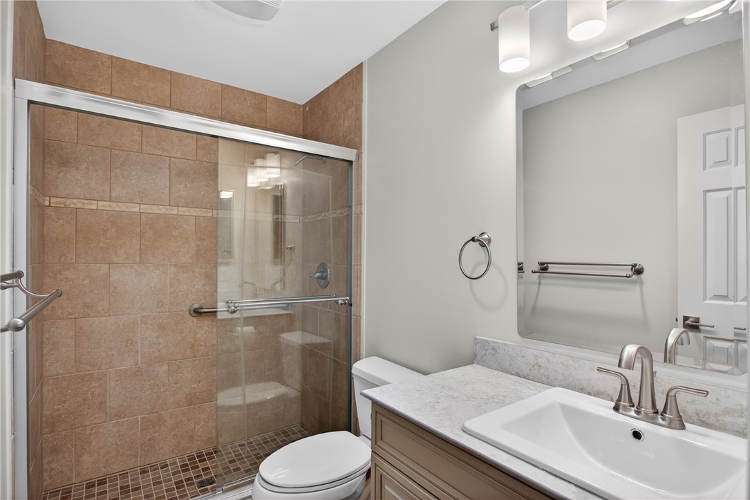 9 Lookout Lane Salem, SC 29676 - Photo 21 of 46 A well-lit bathroom features a modern vanity with a single sink and a spacious glass-enclosed shower.
