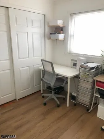 a view of a room with furniture and windows