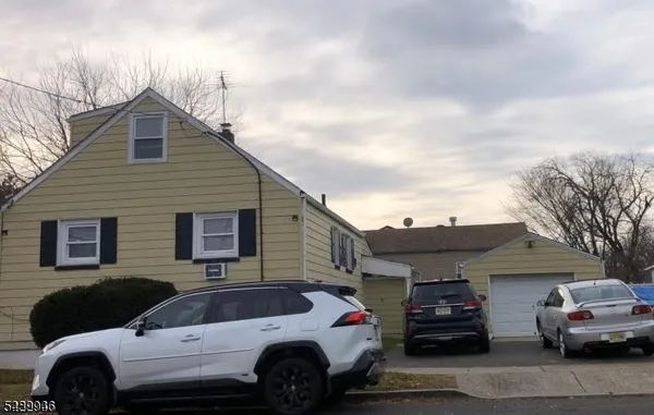 a front view of a house with parking space