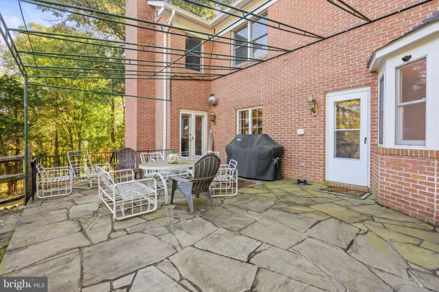 a view of a patio with a table and chairs and potted plants