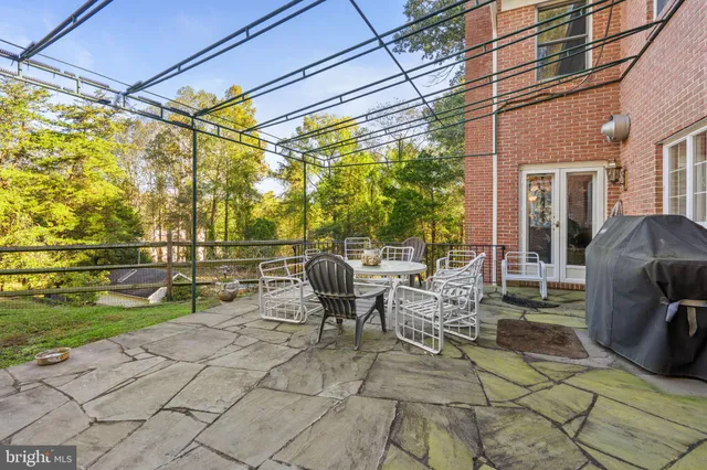 a view of a patio with table and chairs and potted plants