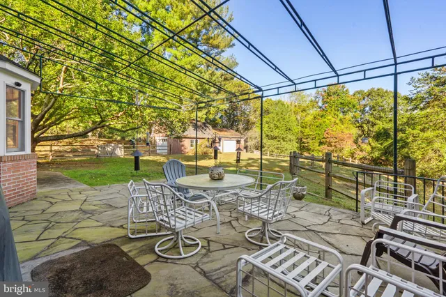 a view of a patio with table and chairs and potted plants