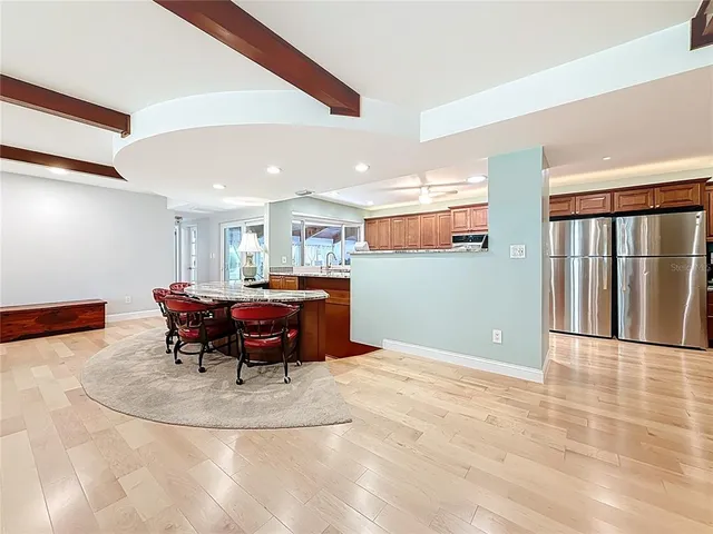 a living room with furniture a fireplace and a ceiling fan