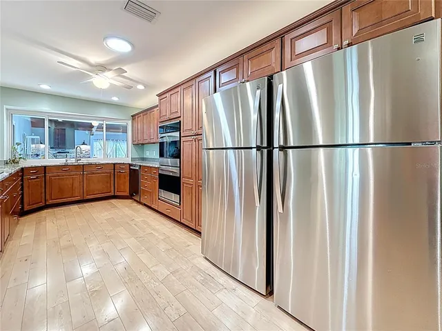 a spacious bathroom with a double vanity sink a mirror and shower