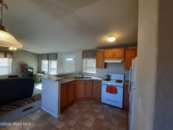 a kitchen with stainless steel appliances granite countertop a sink and cabinets