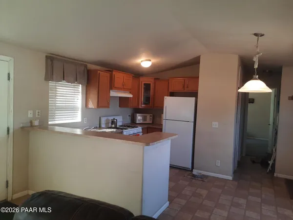 a kitchen with refrigerator and window
