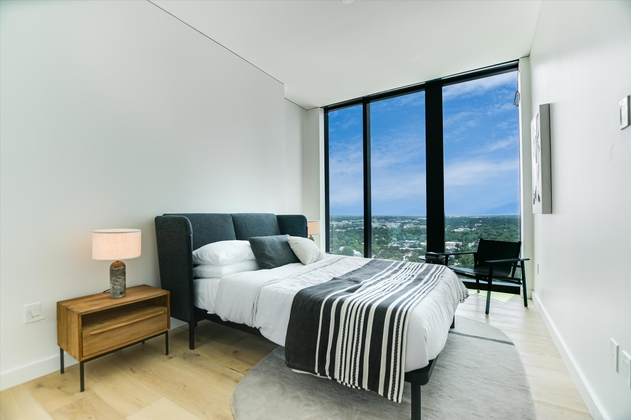 610 Davis Street, Unit 1902 Austin, TX 78701 - Photo 11 of 34 a bedroom with a bed and a night stand