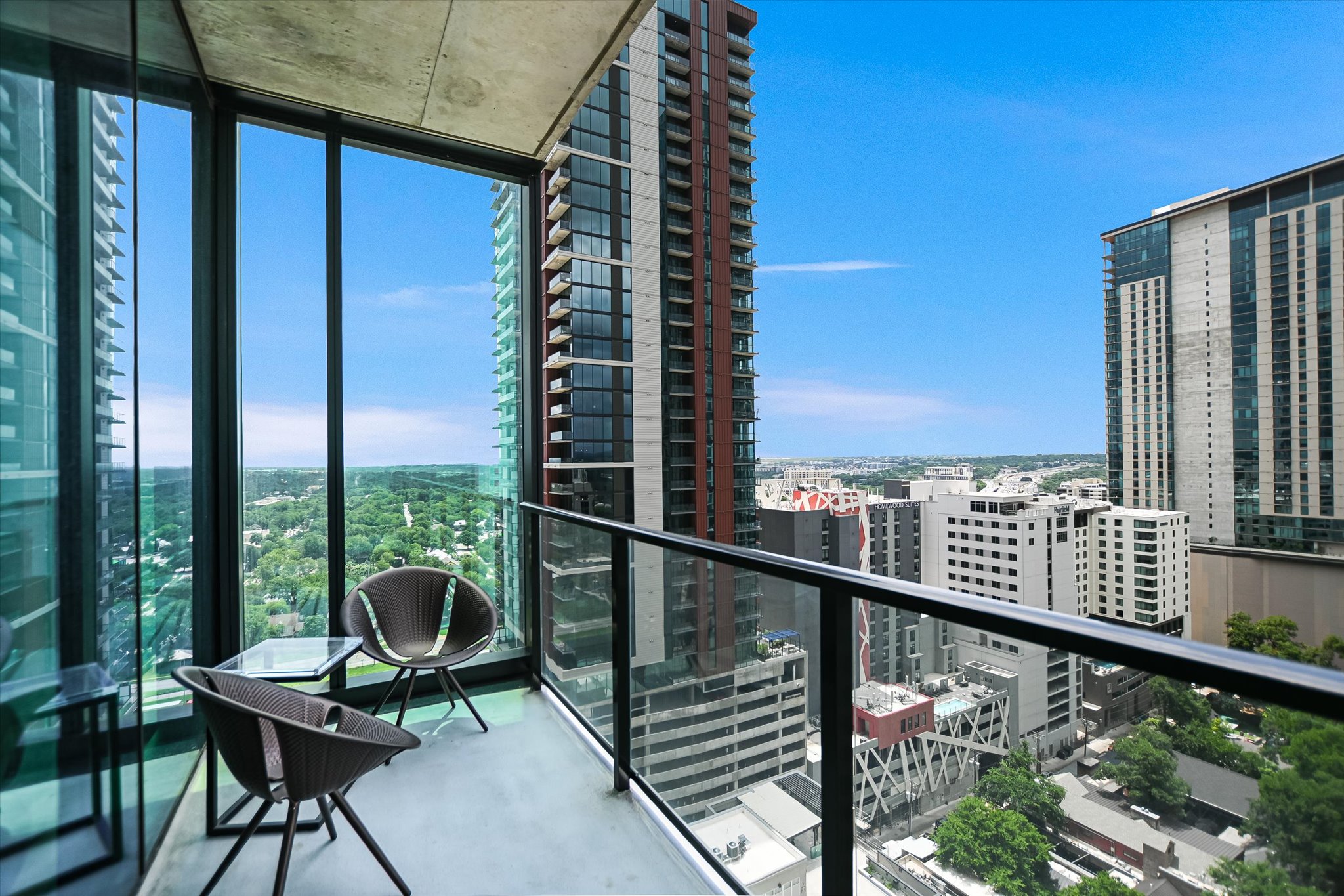 610 Davis Street, Unit 1902 Austin, TX 78701 - Photo 17 of 34 a view of a balcony with chairs and wooden fence