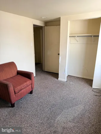 a white toilet sitting next to a bathroom sink and vanity