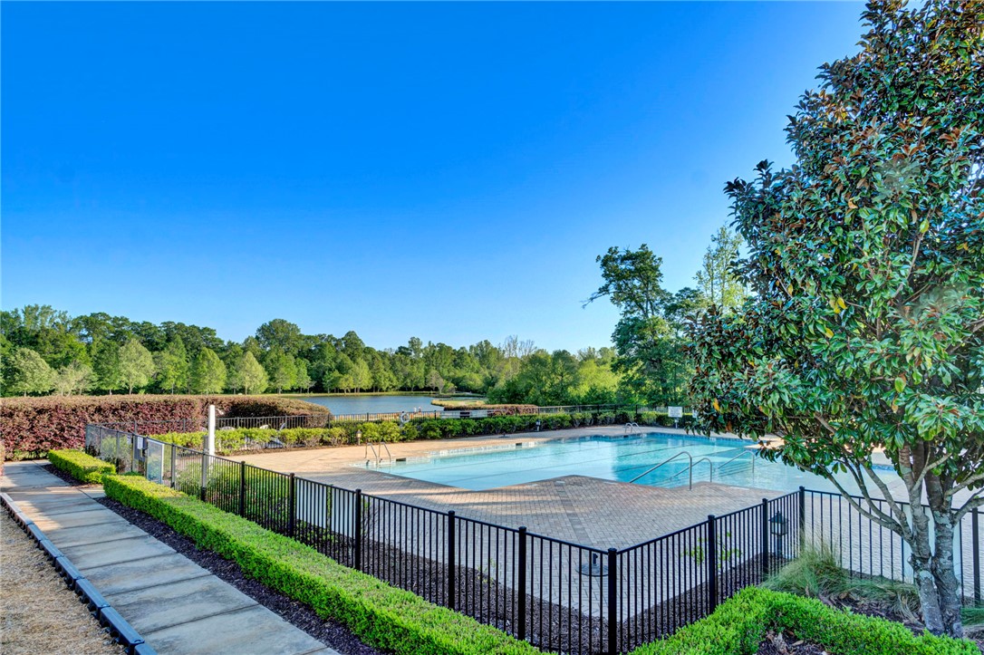 118 Tuttle Street Clemson, SC 29631 - Photo 8 of 9 An inviting pool area with serene lake views, perfect for relaxation and recreation.