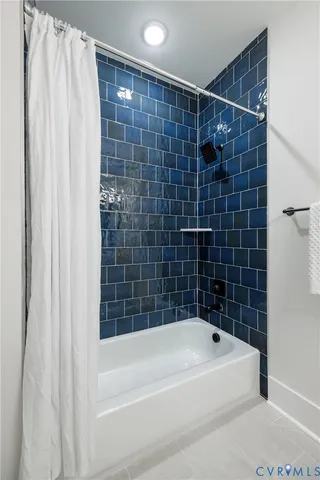 a bathroom with a shower and a bath tub