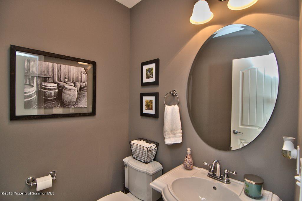 126 Highland Road Moscow, PA 18444 - Photo 24 of 77 a bathroom with a toilet sink and mirror