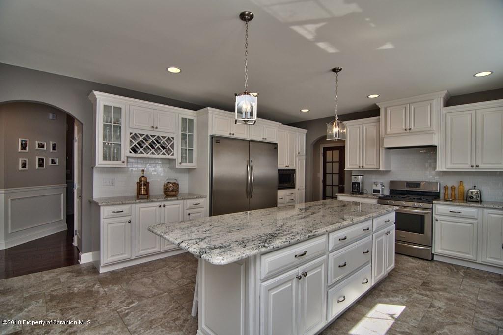 126 Highland Road Moscow, PA 18444 - Photo 32 of 77 a kitchen with granite countertop a sink stove and refrigerator