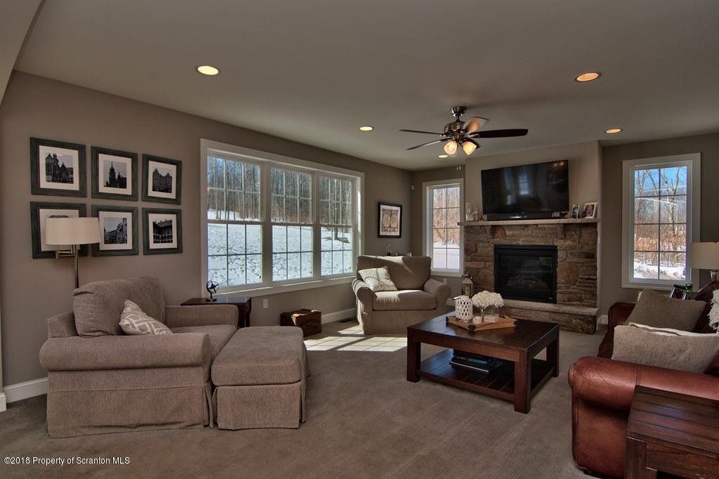 126 Highland Road Moscow, PA 18444 - Photo 39 of 77 a living room with furniture fireplace and a flat screen tv