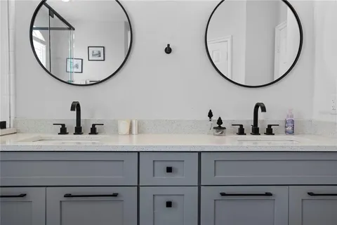 a bathroom with a mirror and a sink with mirror