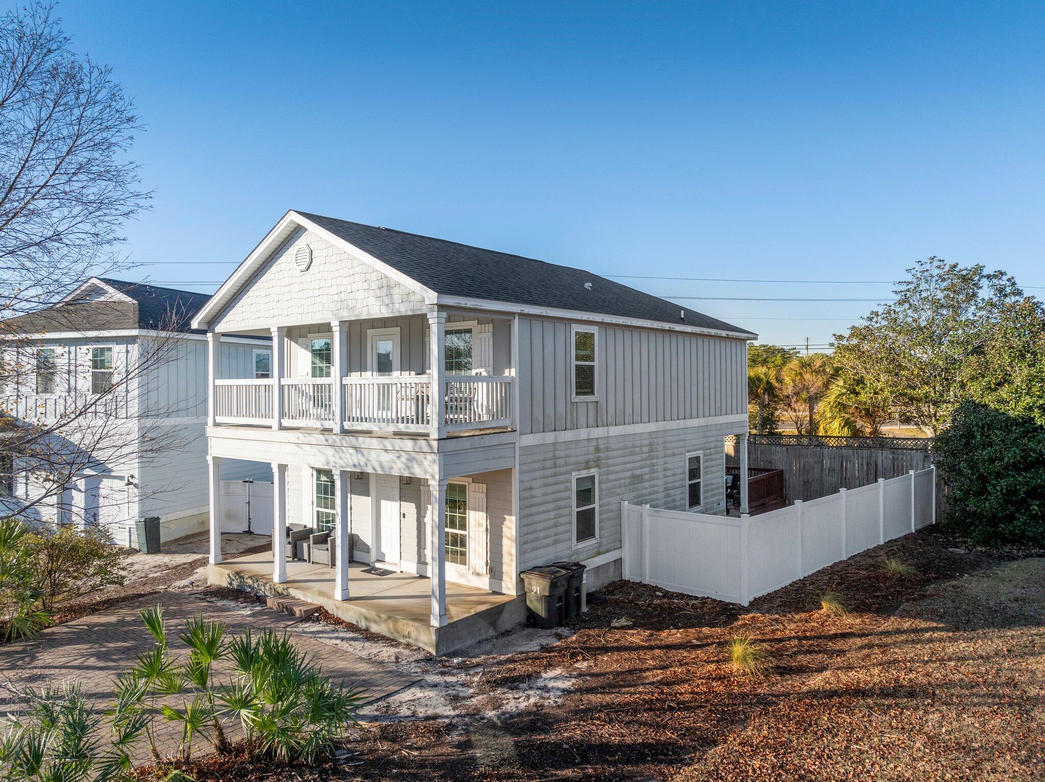 91 Grayling Way Inlet Beach, FL 32461 - Photo 34 of 43 a view of a white house next to a yard with plants and trees