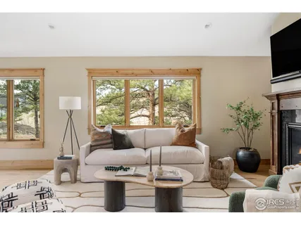 a living room with furniture a flat screen tv and a floor to ceiling window