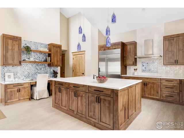 a kitchen that has a lot of cabinets in it and wooden floor