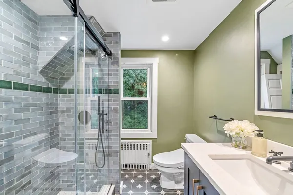 a bathroom with a sink toilet and shower