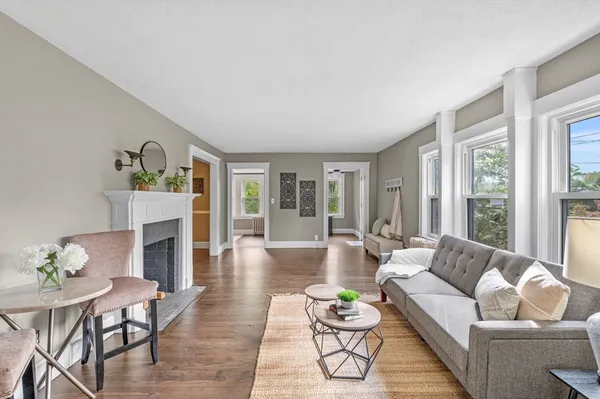 a living room with furniture and a fireplace
