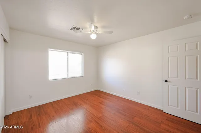 wooden floor in an empty room with a window