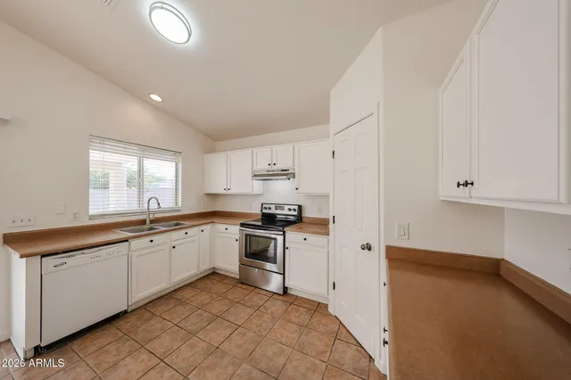 a kitchen with a sink stove and cabinets
