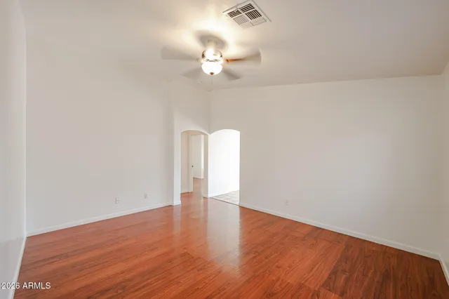 a view of a room with wooden floor and chandelier