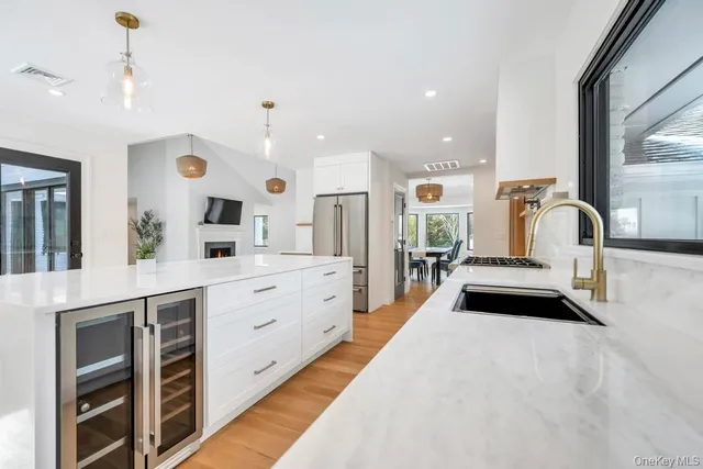 a view of a living room kitchen and a wooden floor