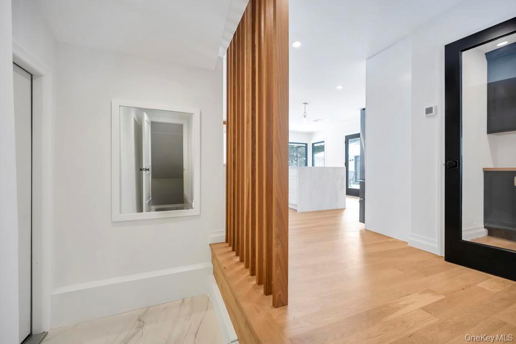 10 Lenape Road Southampton, NY 11968 - Photo 14 of 37 a view of a hallway with wooden floor and a living room