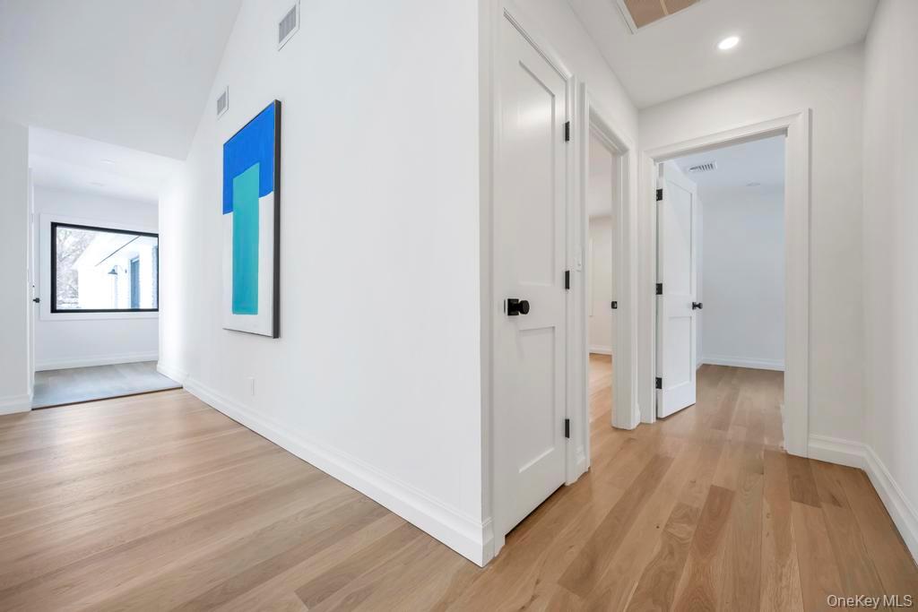 10 Lenape Road Southampton, NY 11968 - Photo 18 of 37 a view of an empty room with wooden floor and a window