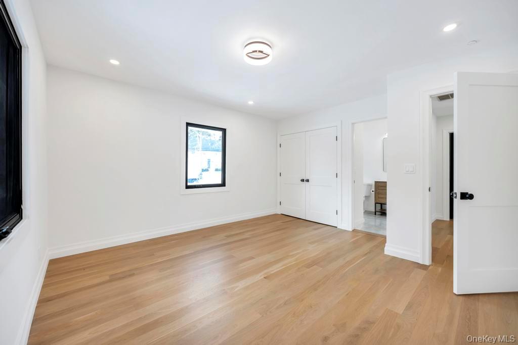 10 Lenape Road Southampton, NY 11968 - Photo 27 of 37 a view of an empty room with wooden floor and a window