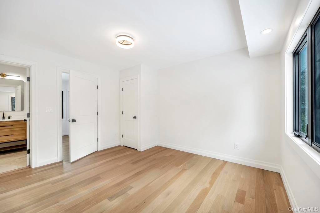 10 Lenape Road Southampton, NY 11968 - Photo 29 of 37 a view of empty room with wooden floor and fan