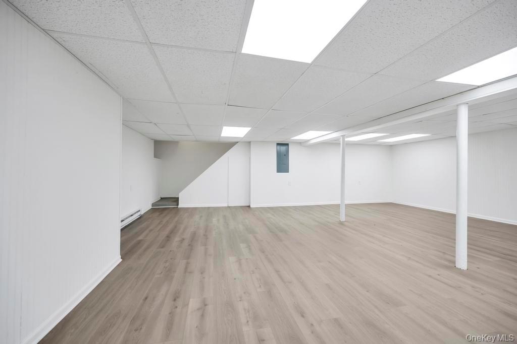 10 Lenape Road Southampton, NY 11968 - Photo 32 of 37 an empty room with wooden floor and windows