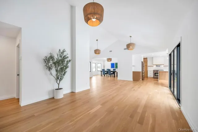 a large kitchen with kitchen island a sink stainless steel appliances and cabinets