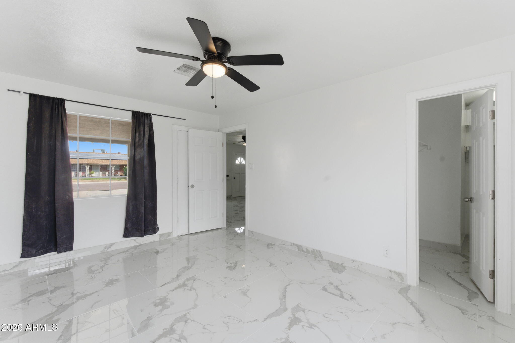 4251 West Rose Lane Phoenix, AZ 85019 - Photo 11 of 24 a view of a livingroom with a ceiling fan and window