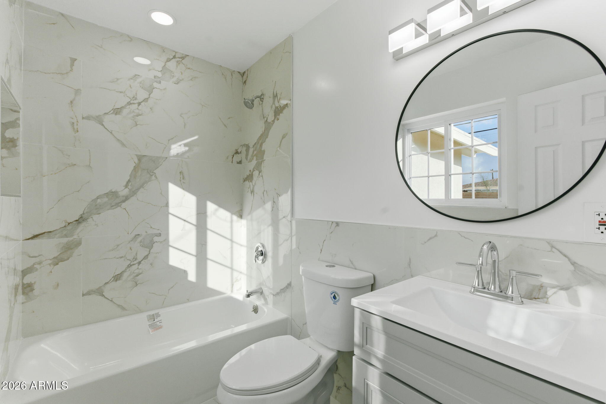 4251 West Rose Lane Phoenix, AZ 85019 - Photo 17 of 24 a bathroom with a sink a toilet and a mirror