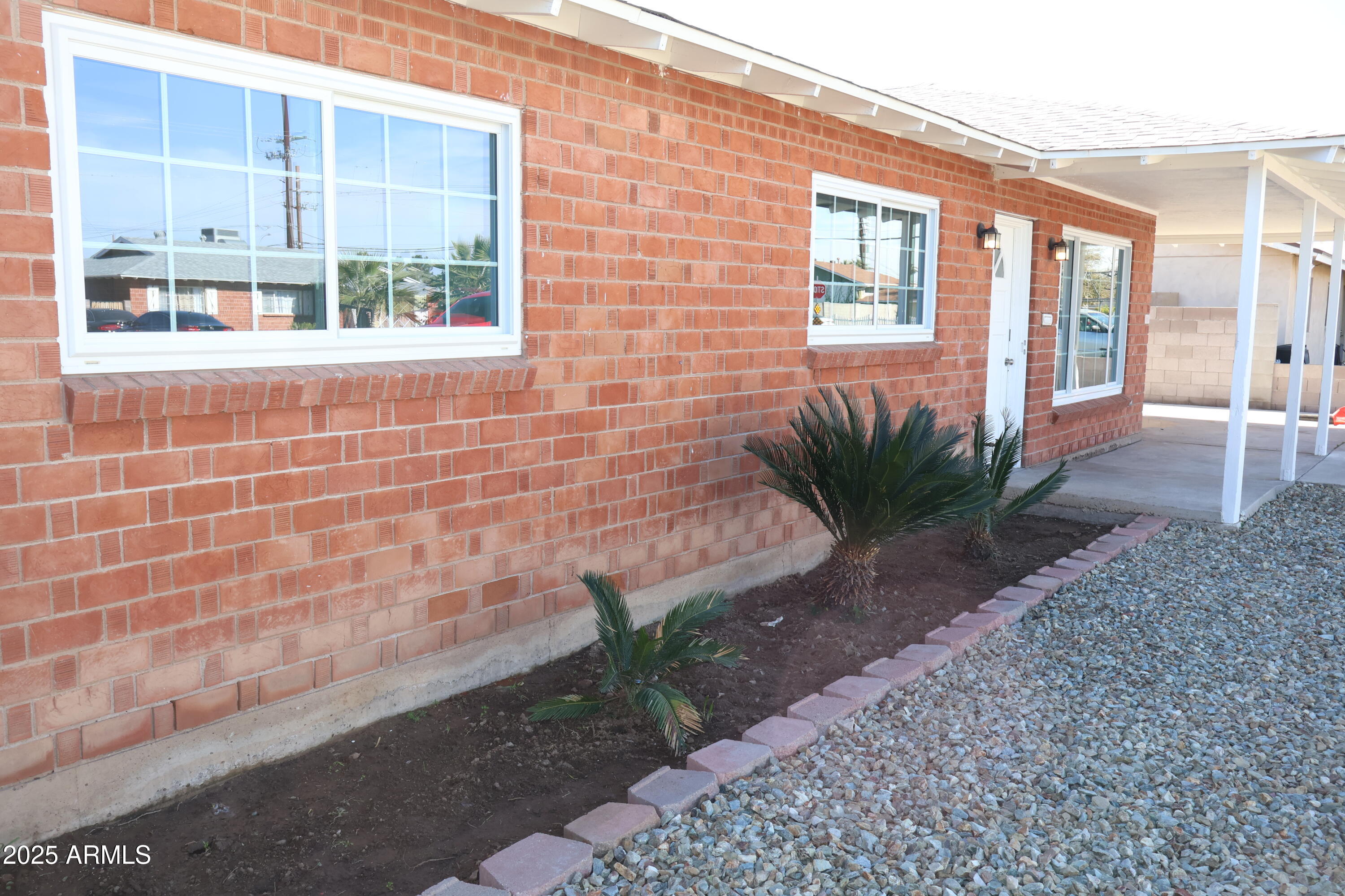 4251 West Rose Lane Phoenix, AZ 85019 - Photo 22 of 24 a view of a brick house with many windows