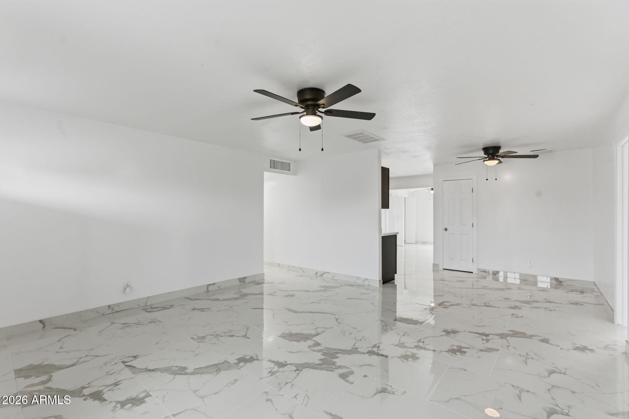 4251 West Rose Lane Phoenix, AZ 85019 - Photo 3 of 24 wooden floor in an empty room