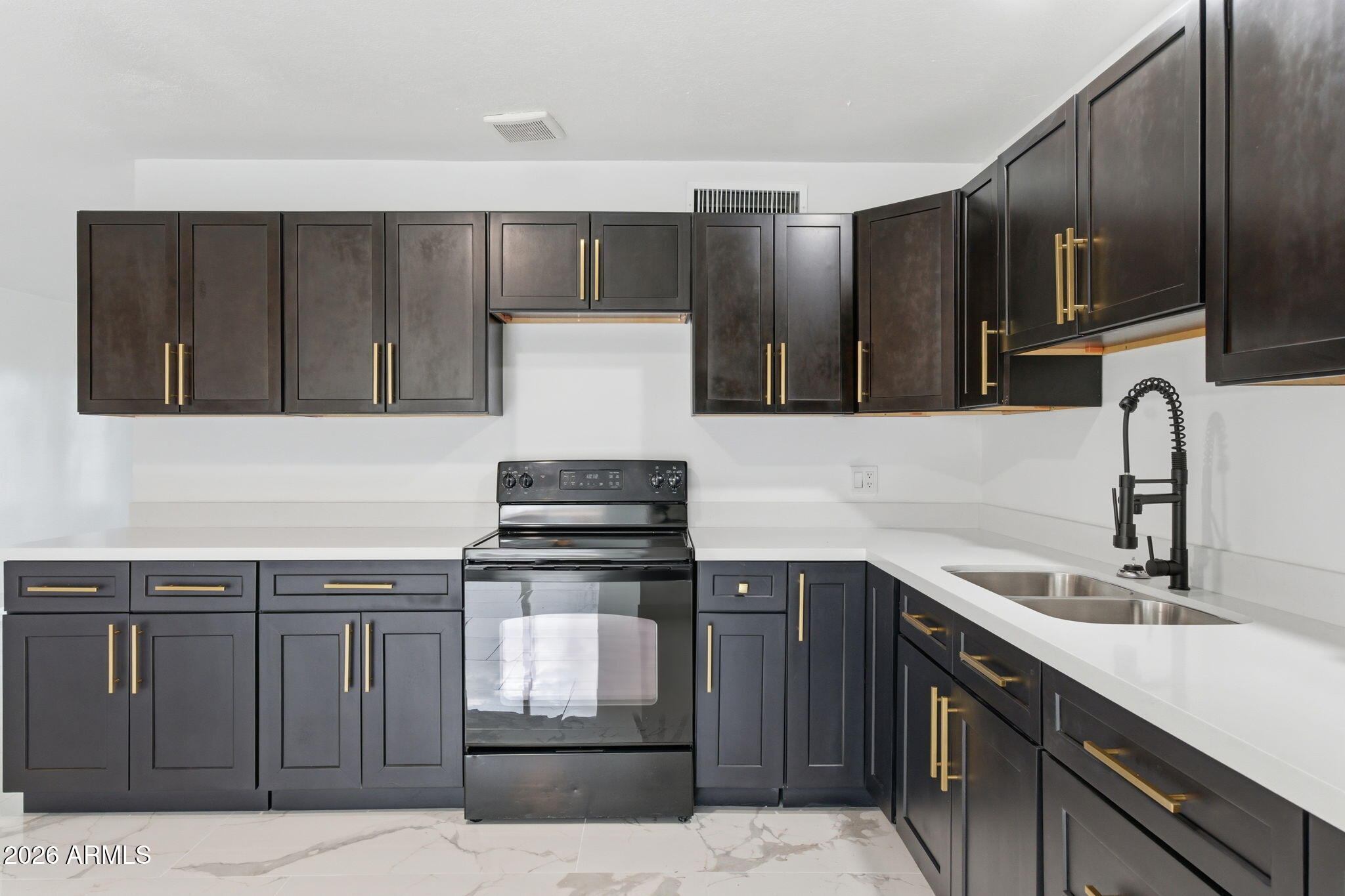 4251 West Rose Lane Phoenix, AZ 85019 - Photo 7 of 24 a kitchen with stainless steel appliances a sink stove and cabinets