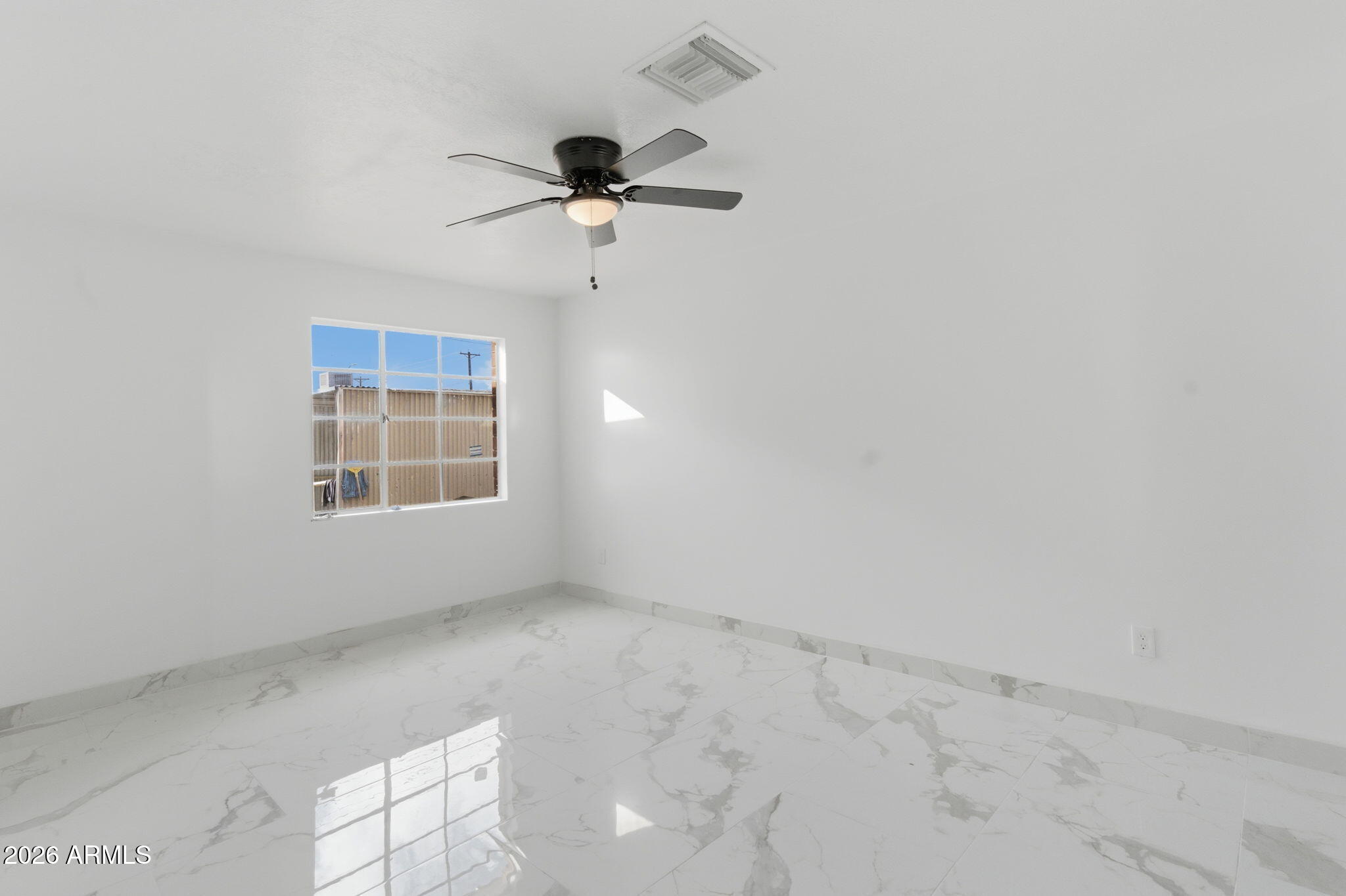 4251 West Rose Lane Phoenix, AZ 85019 - Photo 10 of 24 an empty room with a window
